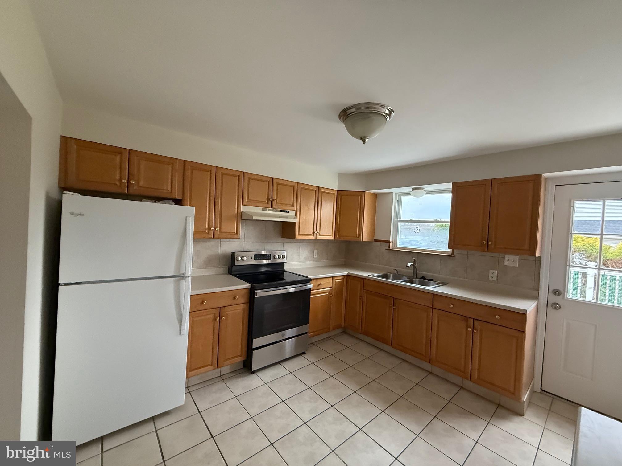 1100 Chews Landing Road Laurel Springs, NJ 08021 - Photo 14 of 33 a kitchen with stainless steel appliances granite countertop a refrigerator sink and stove