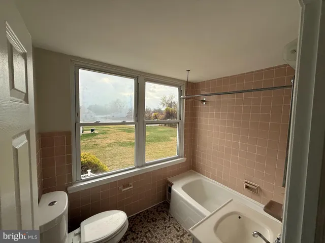 a bathroom with a toilet sink and tub