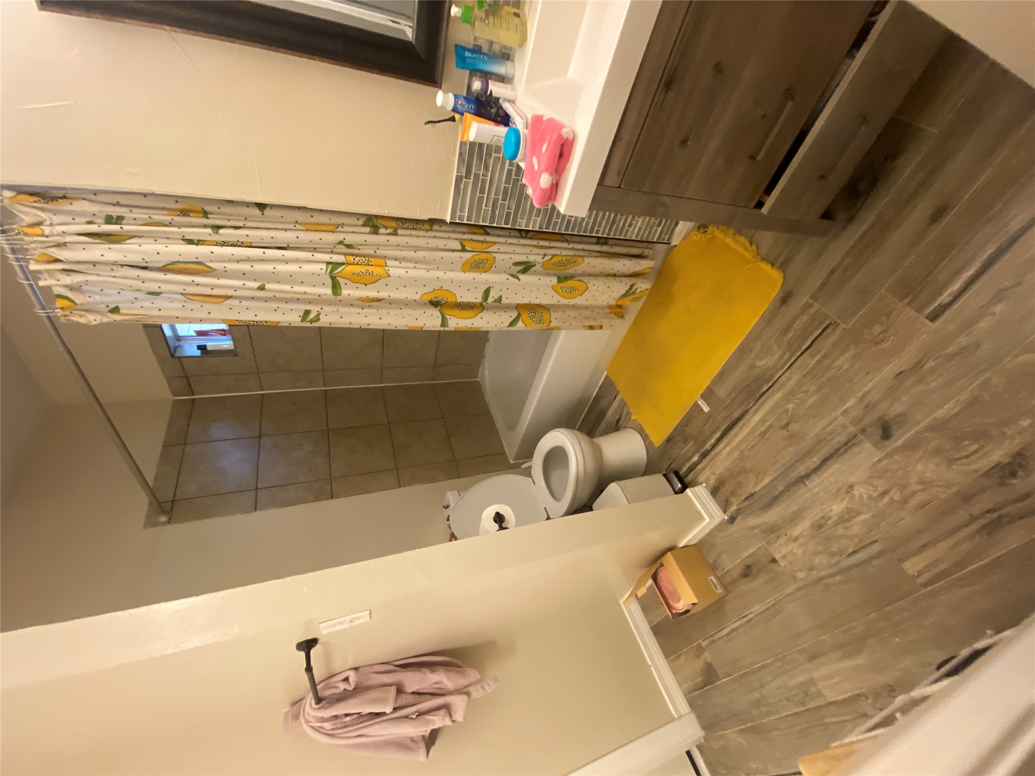 3010 Fruth Street, Unit A Austin, TX 78705 - Photo 19 of 39 Bathroom featuring wood-finish flooring, a contemporary vanity with a white countertop, and a tiled shower/tub combination