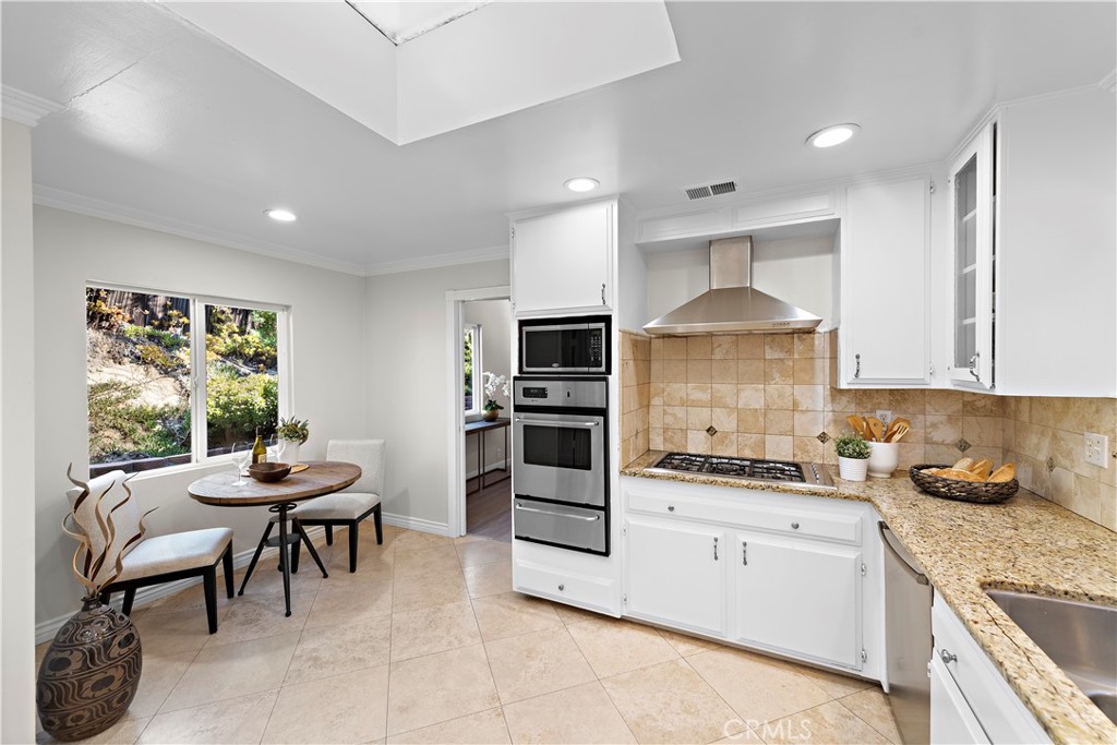 3044 Cresta Way Laguna Beach, CA 92651 - Photo 14 of 48 a kitchen with stainless steel appliances kitchen island granite countertop a sink and cabinets