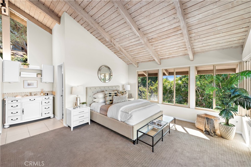 3044 Cresta Way Laguna Beach, CA 92651 - Photo 20 of 48 a bed sitting in a spacious bedroom next to a window