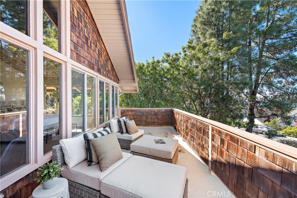3044 Cresta Way Laguna Beach, CA 92651 - Photo 24 of 48 a balcony with wooden floor and outdoor seating