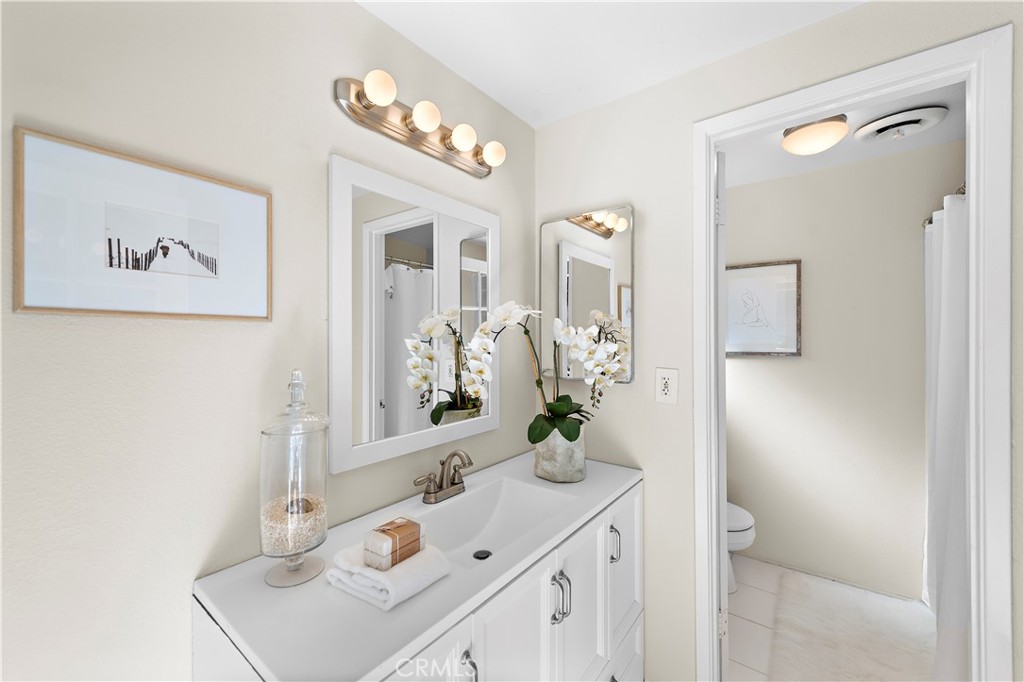 3044 Cresta Way Laguna Beach, CA 92651 - Photo 28 of 48 a bathroom with a sink and a mirror