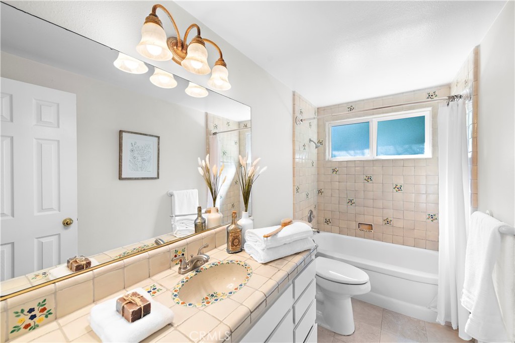 3044 Cresta Way Laguna Beach, CA 92651 - Photo 32 of 48 a bathroom with a granite countertop sink a toilet and a mirror