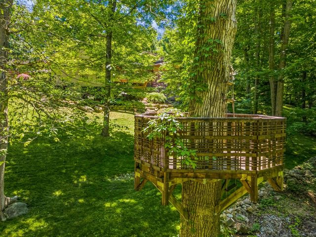 an aerial view of a house with garden space and street view