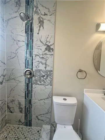 a bathroom with a toilet and shower
