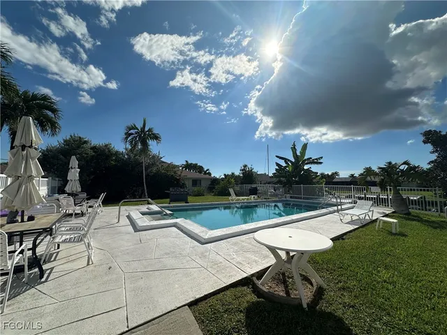 a view of a swimming pool with a garden and trees