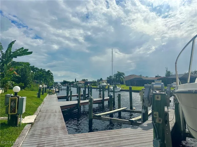 a view of a lake with a wooden bridge