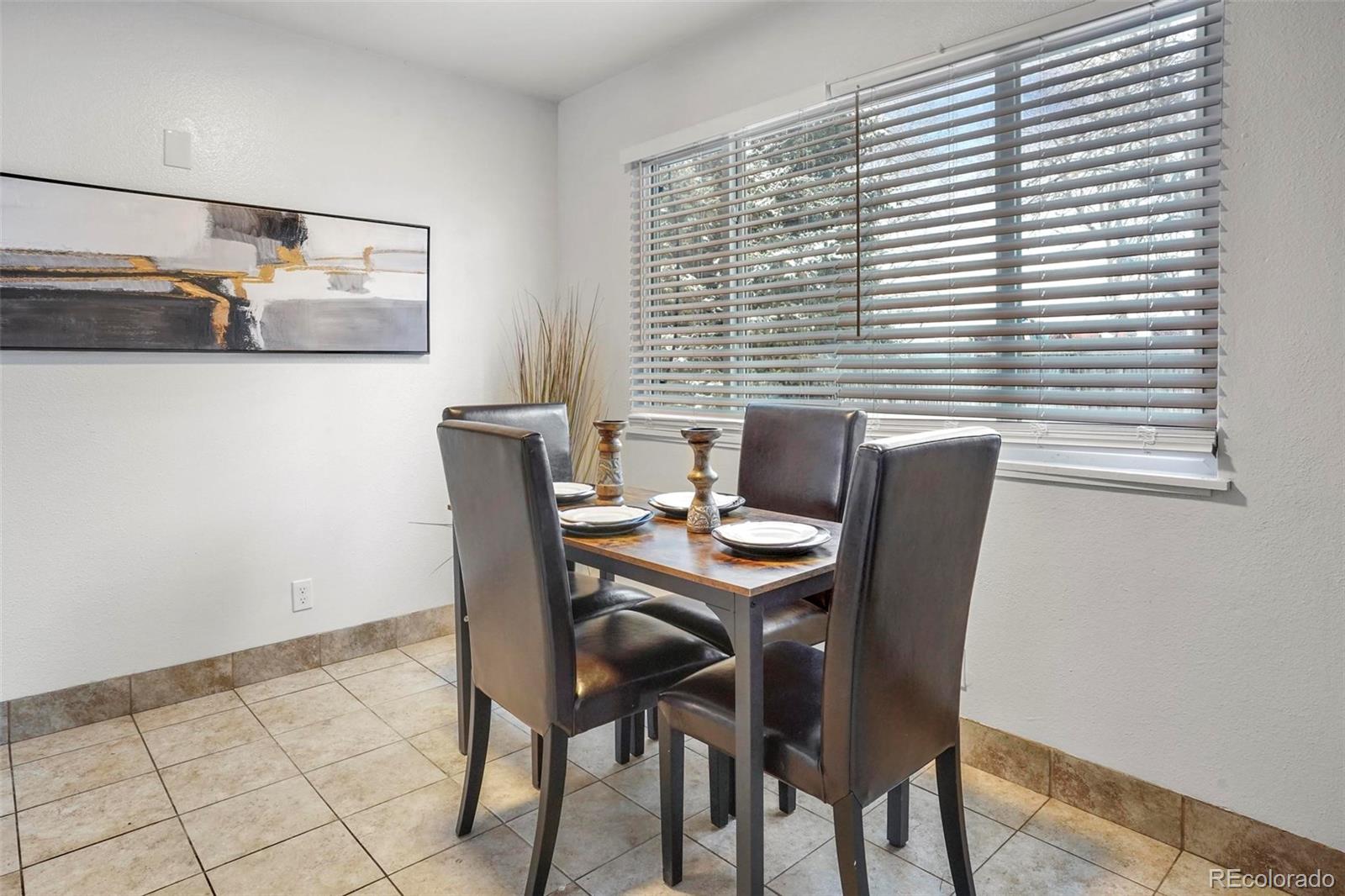 5522 Carson Street Denver, CO 80239 - Photo 11 of 40 a view of a dining room with furniture and window