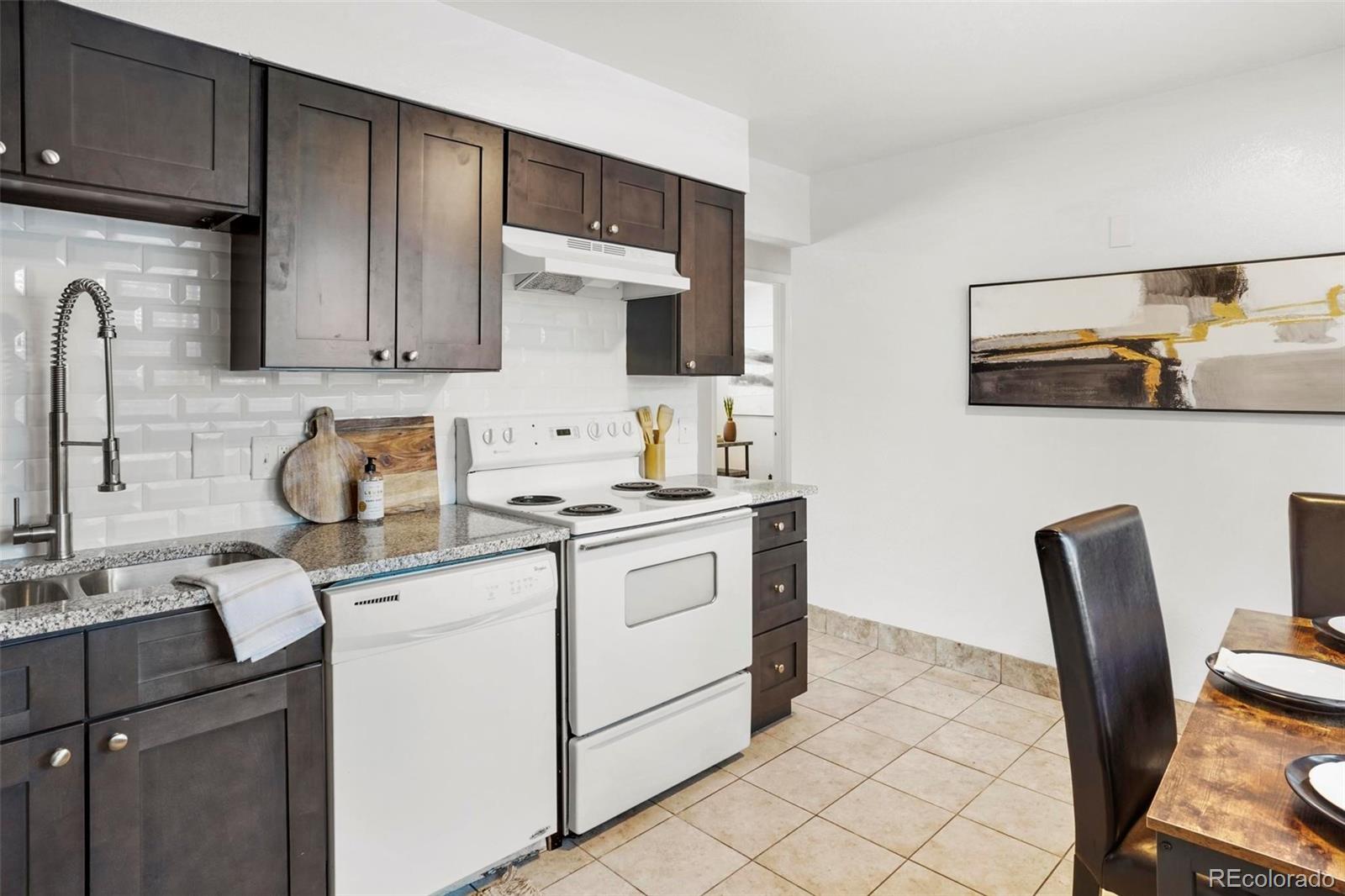 5522 Carson Street Denver, CO 80239 - Photo 15 of 40 a kitchen with a sink cabinets and appliances