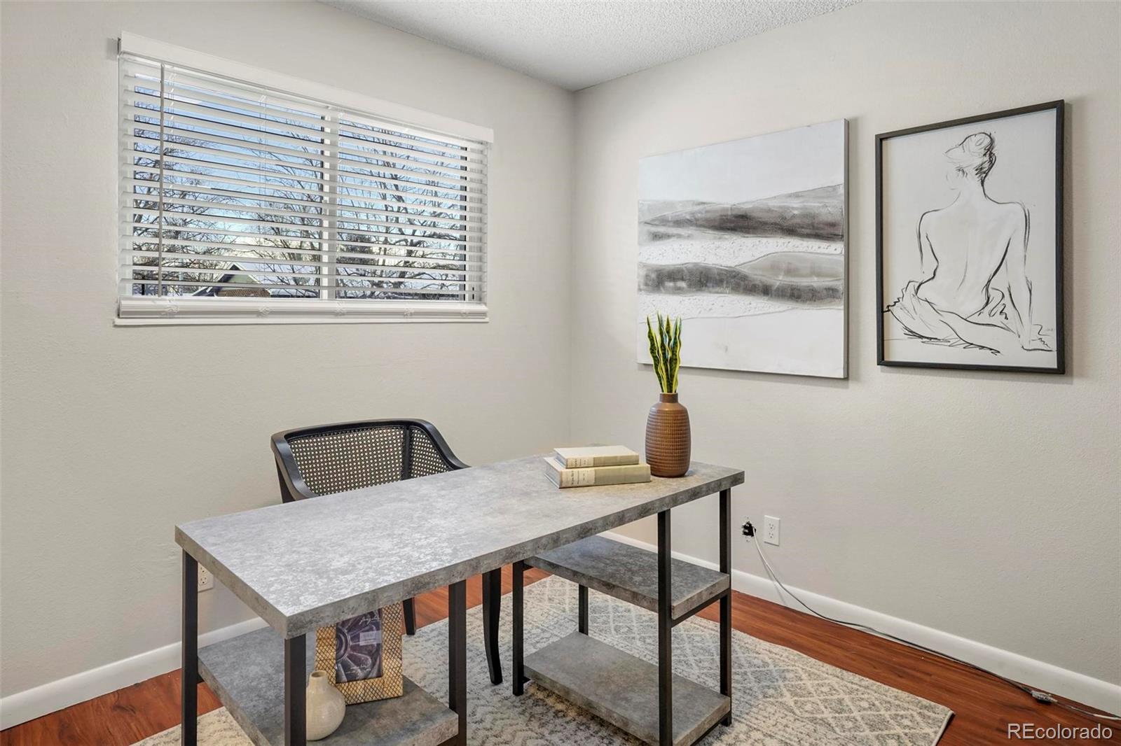 5522 Carson Street Denver, CO 80239 - Photo 16 of 40 a view of a workspace with furniture and window