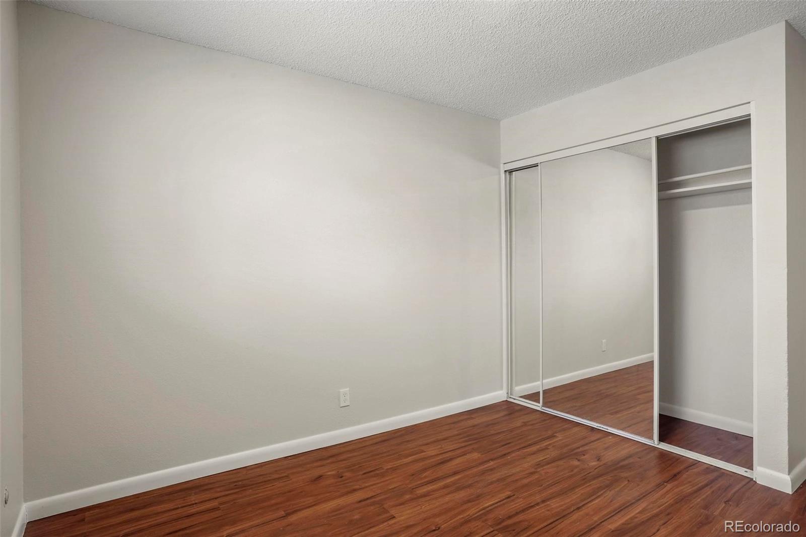 5522 Carson Street Denver, CO 80239 - Photo 24 of 40 a view of an empty room with wooden floor