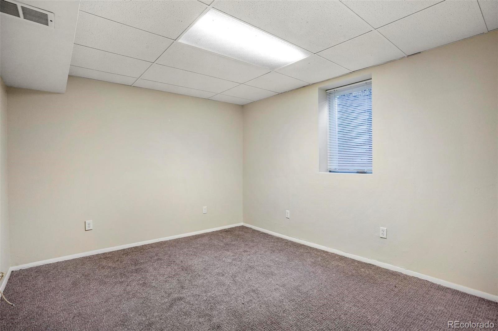 5522 Carson Street Denver, CO 80239 - Photo 28 of 40 an empty room with a windows