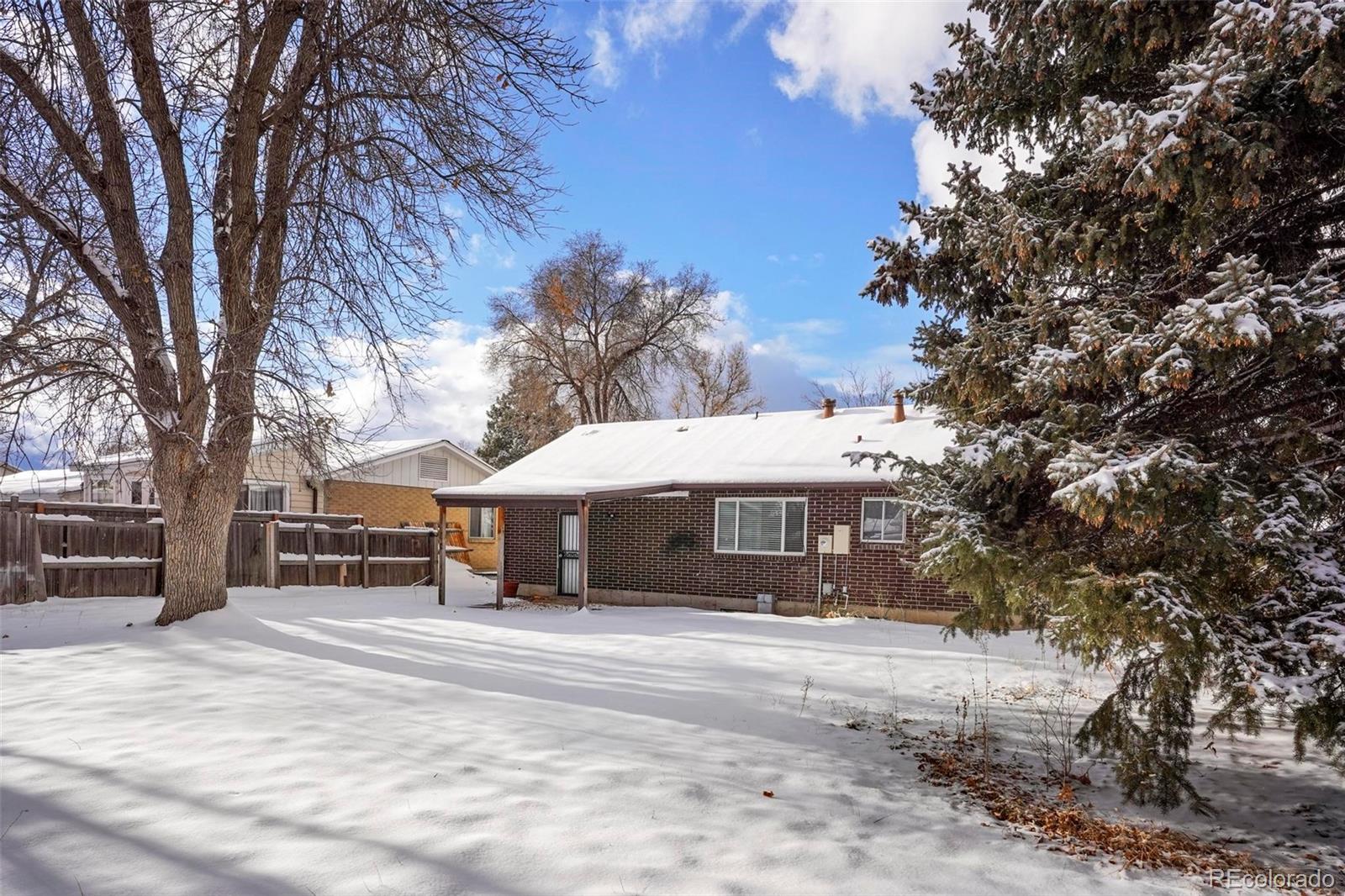 5522 Carson Street Denver, CO 80239 - Photo 35 of 40 a view of a house with a yard