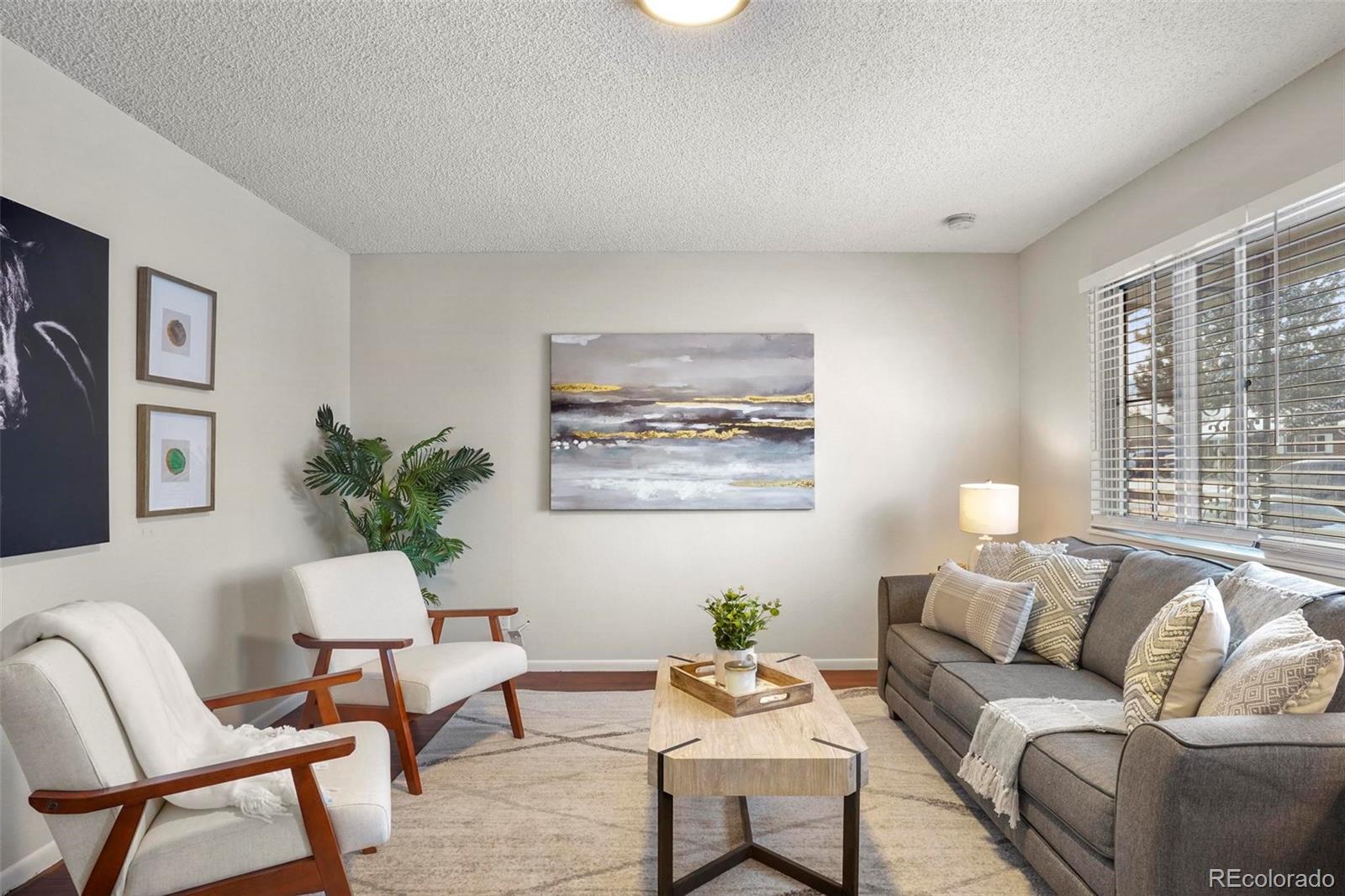 5522 Carson Street Denver, CO 80239 - Photo 6 of 40 a living room with furniture and a large window