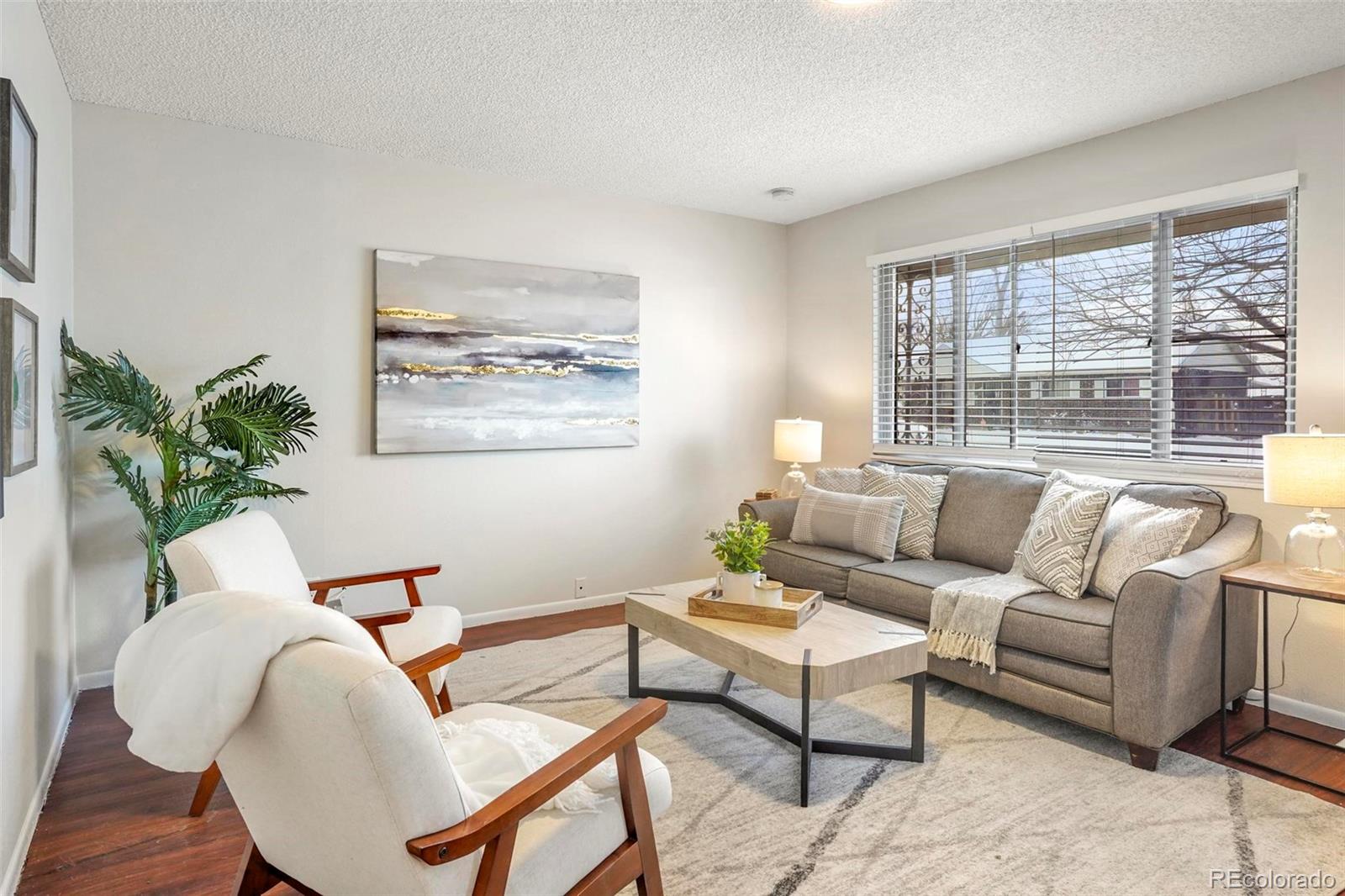 5522 Carson Street Denver, CO 80239 - Photo 7 of 40 a living room with furniture and a large window