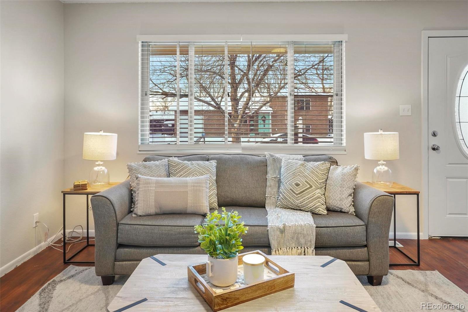 5522 Carson Street Denver, CO 80239 - Photo 8 of 40 a living room with furniture and a large window