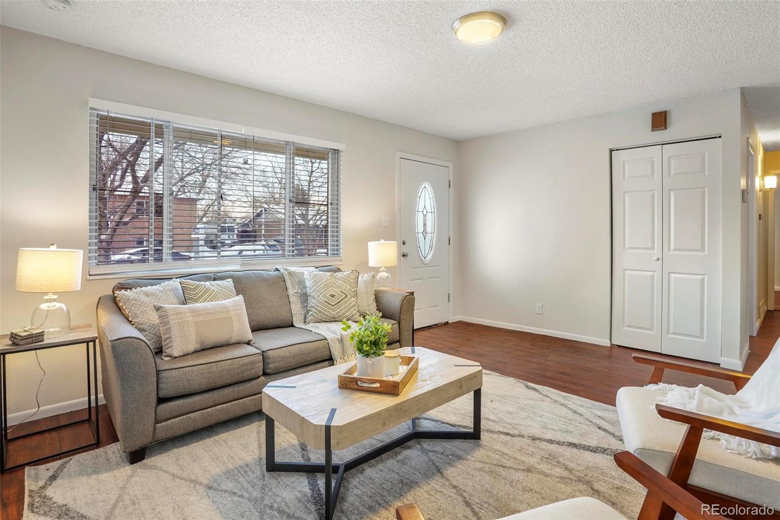 5522 Carson Street Denver, CO 80239 - Photo 9 of 40 a living room with furniture and a large window