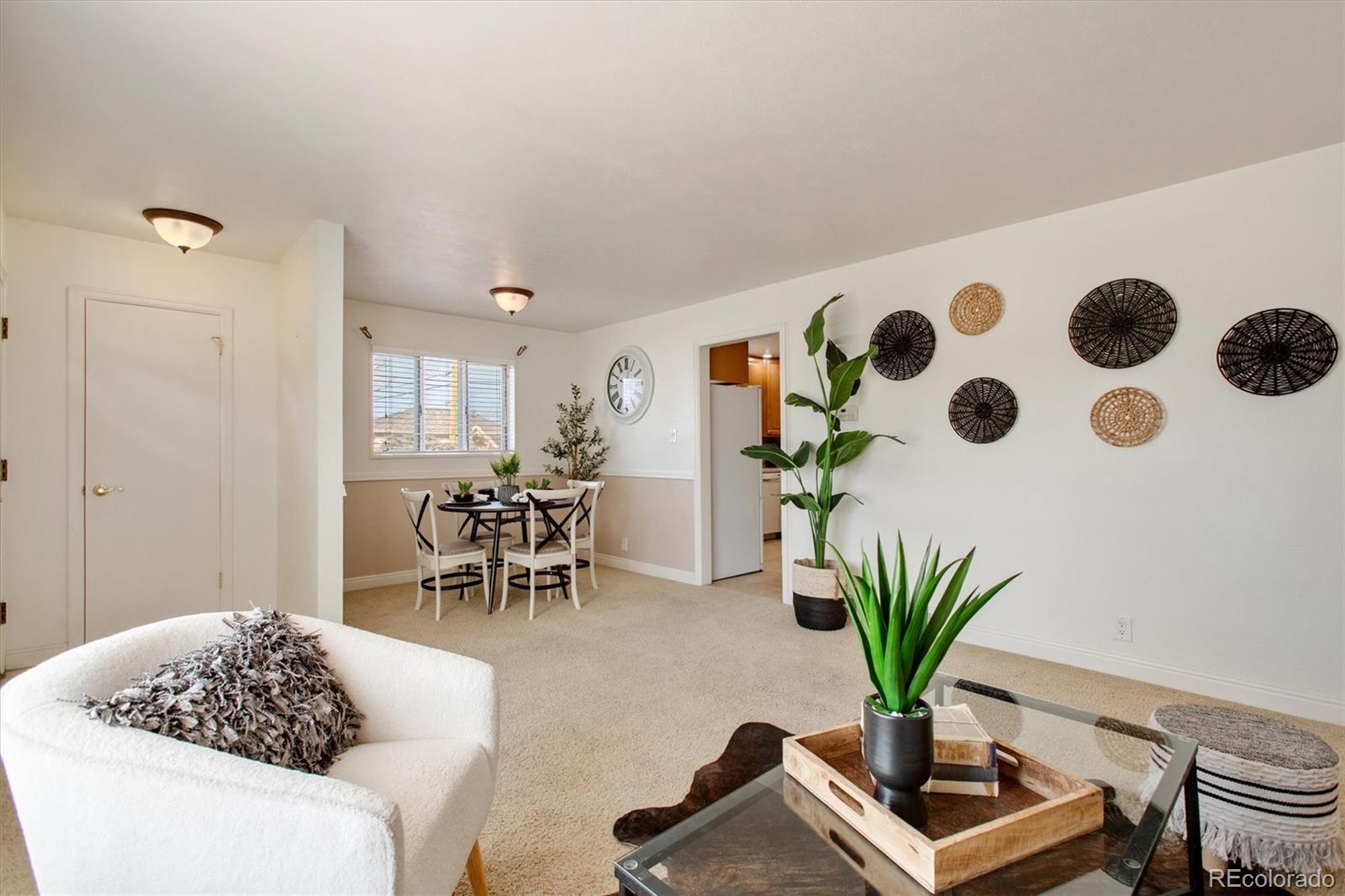 7798 Quivas Street Denver, CO 80221 - Photo 1 of 39 a living room with furniture and potted plant