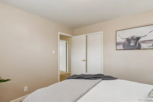 a bedroom with a bed and wall painting