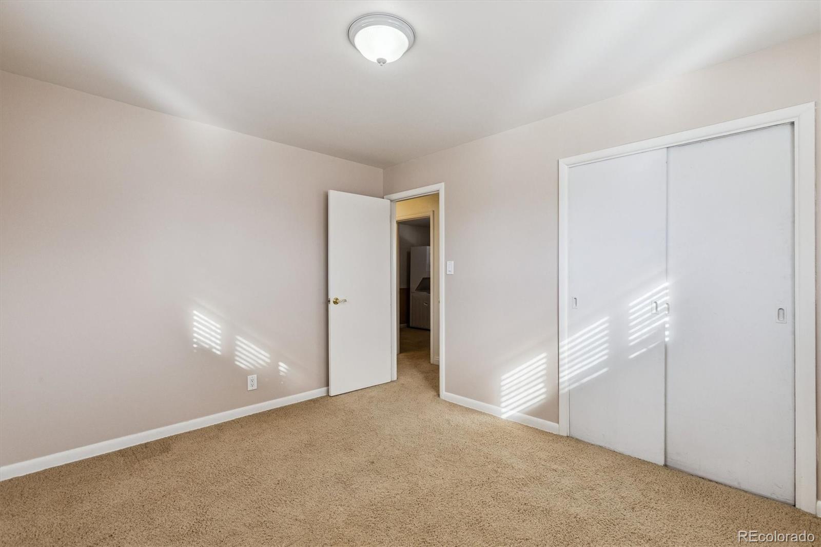 7798 Quivas Street Denver, CO 80221 - Photo 18 of 39 an empty room with an entryway
