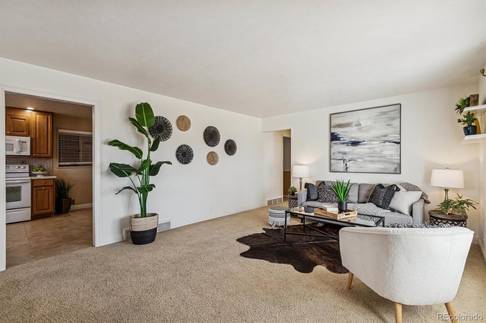 7798 Quivas Street Denver, CO 80221 - Photo 2 of 39 a living room with furniture and potted plant