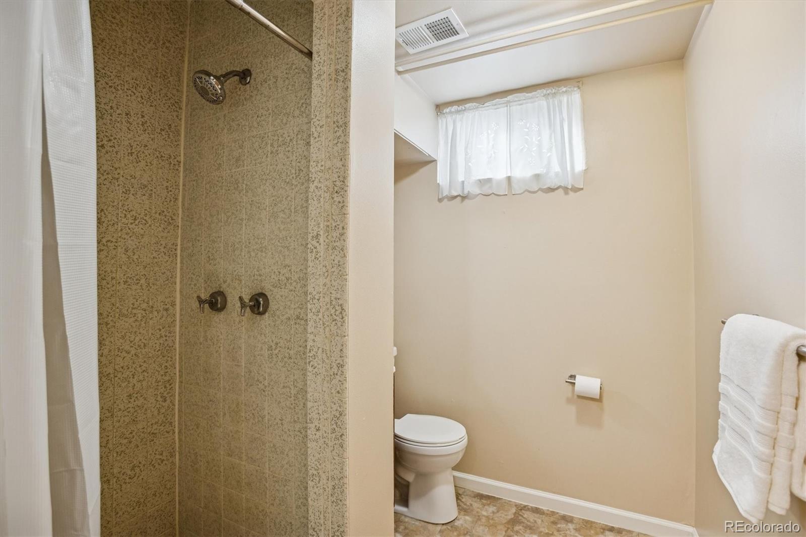 7798 Quivas Street Denver, CO 80221 - Photo 26 of 39 a bathroom with a shower and a toilet