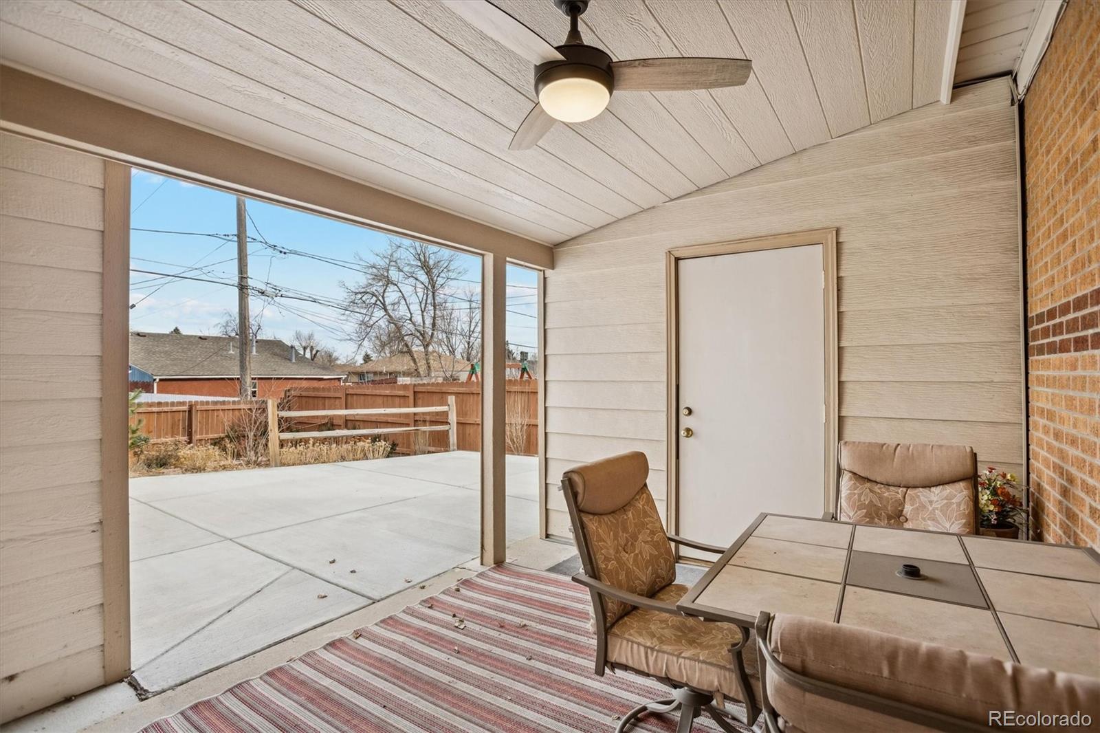 7798 Quivas Street Denver, CO 80221 - Photo 31 of 39 a living room with furniture and a floor to ceiling window