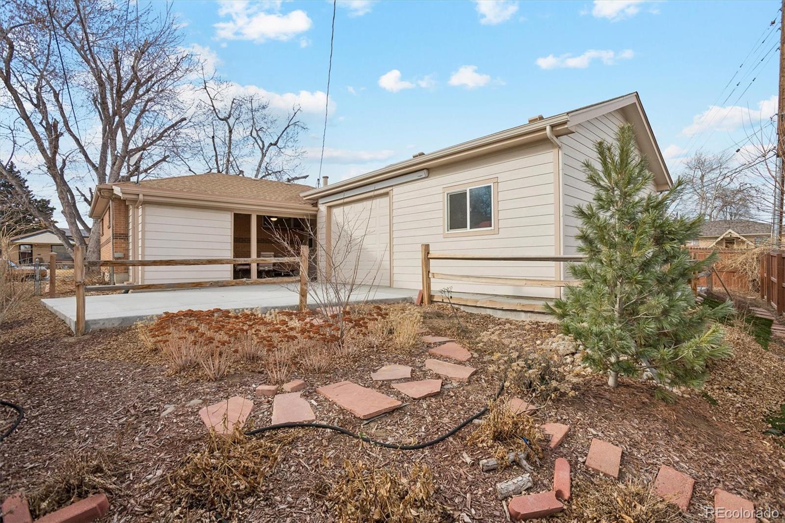 7798 Quivas Street Denver, CO 80221 - Photo 36 of 39 a view of a house with a yard