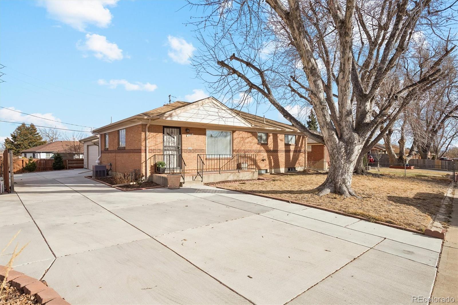7798 Quivas Street Denver, CO 80221 - Photo 6 of 39 a front view of a house with a garden