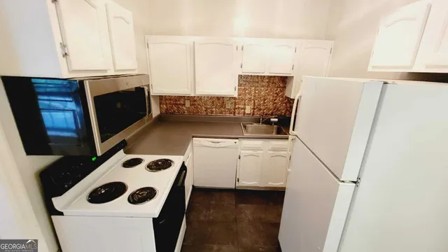 a bathroom with a tub sink and toilet