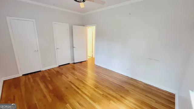 a view of empty room with wooden floor