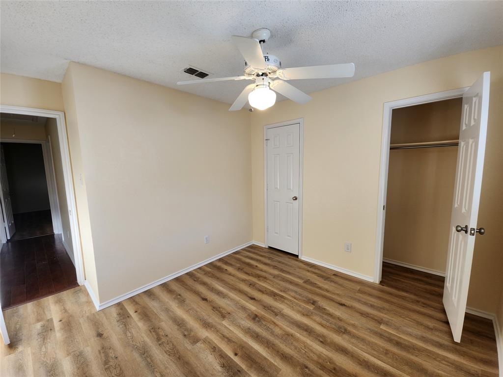 2413 Timber Ridge Lane Flower Mound, TX 75028 - Photo 28 of 32 Room featuring wood-finish flooring, a ceiling fan with integrated lighting, and neutral-toned walls