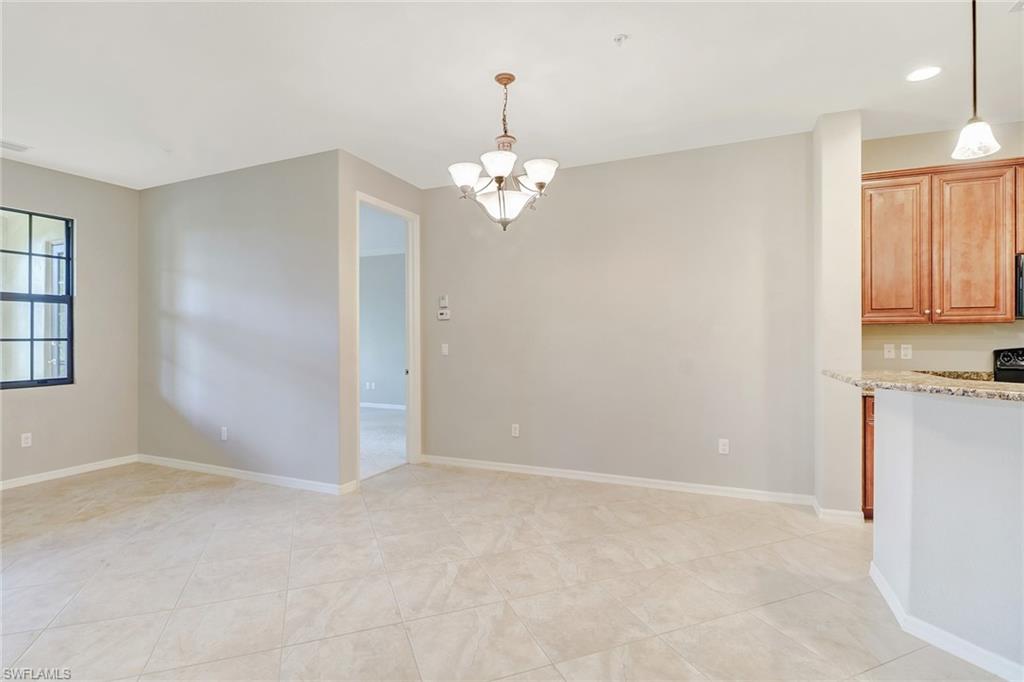 8975 Malibu Street, Unit 1302 Naples, FL 34113 - Photo 11 of 34 wooden floor in an empty room with a window