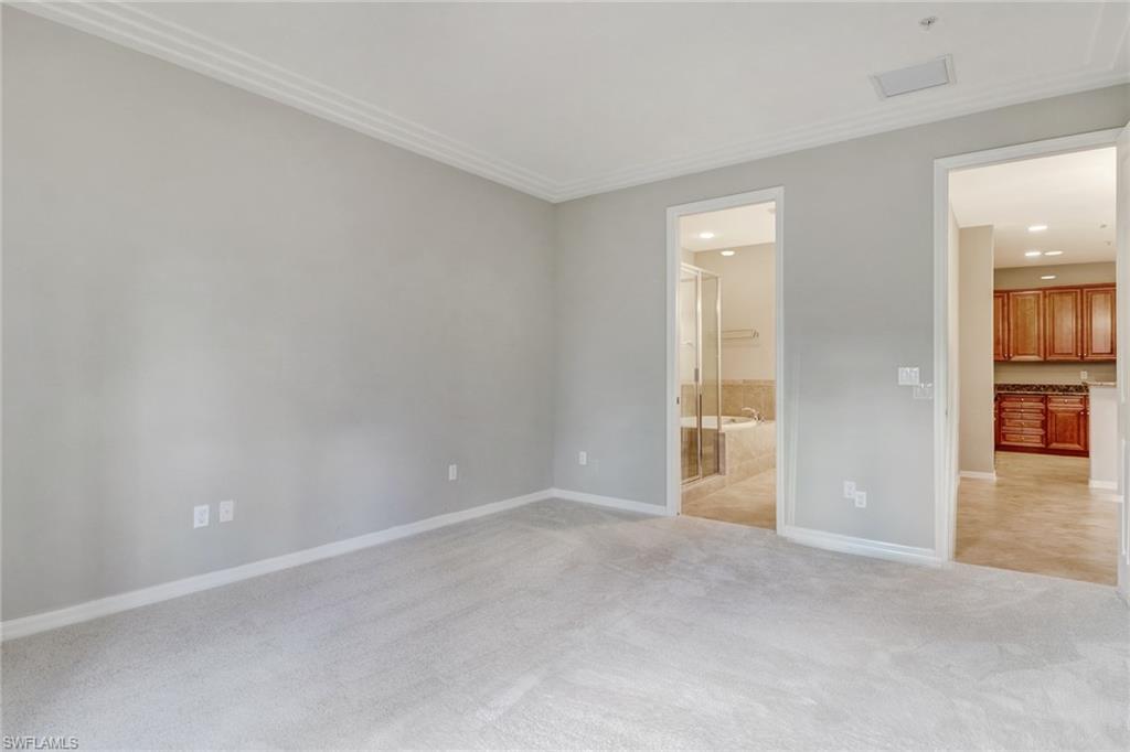 8975 Malibu Street, Unit 1302 Naples, FL 34113 - Photo 14 of 34 an empty room with windows and entrance