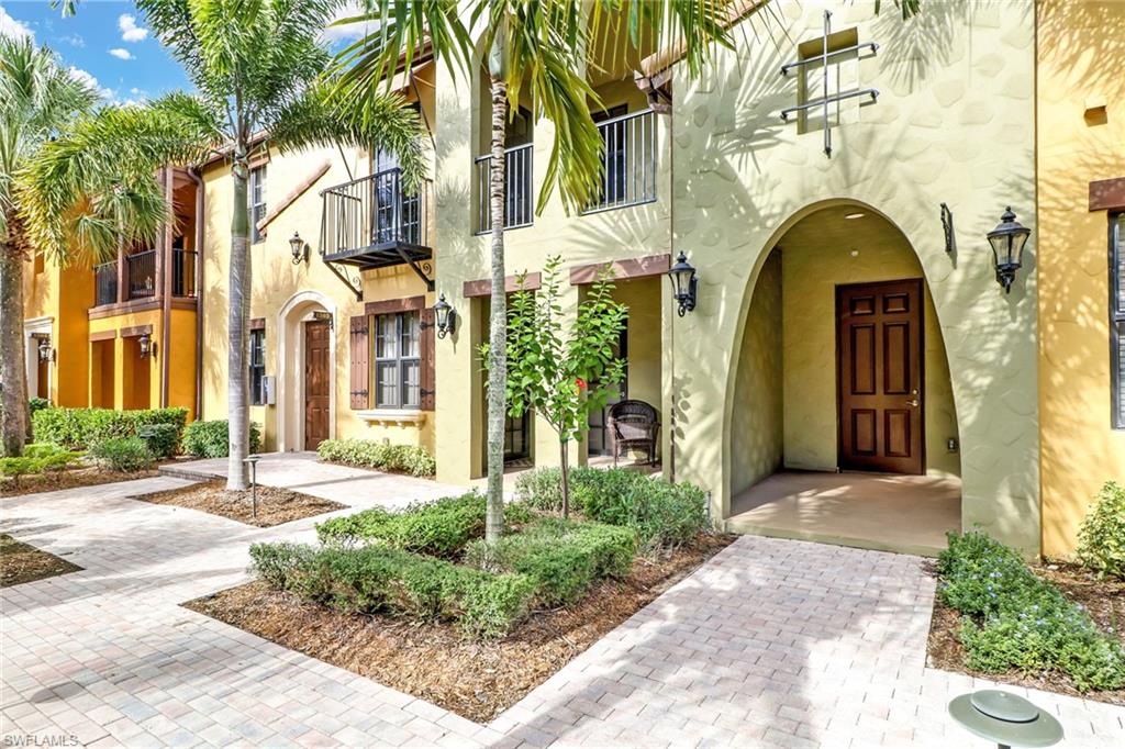 8975 Malibu Street, Unit 1302 Naples, FL 34113 - Photo 2 of 34 a front view of a house with a garden