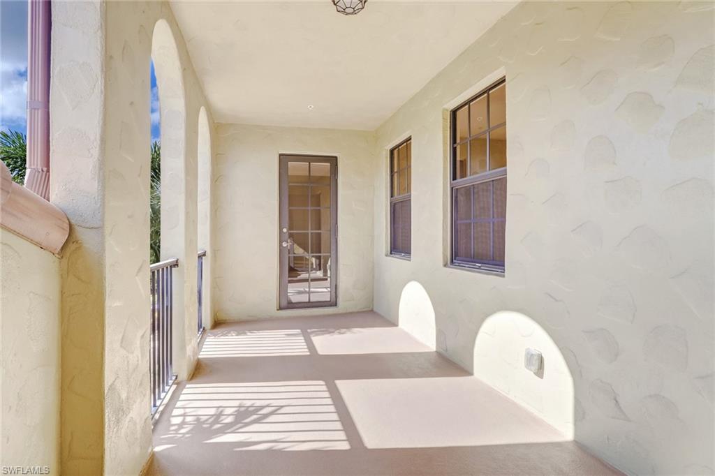 8975 Malibu Street, Unit 1302 Naples, FL 34113 - Photo 23 of 34 a front view of a house with a garden