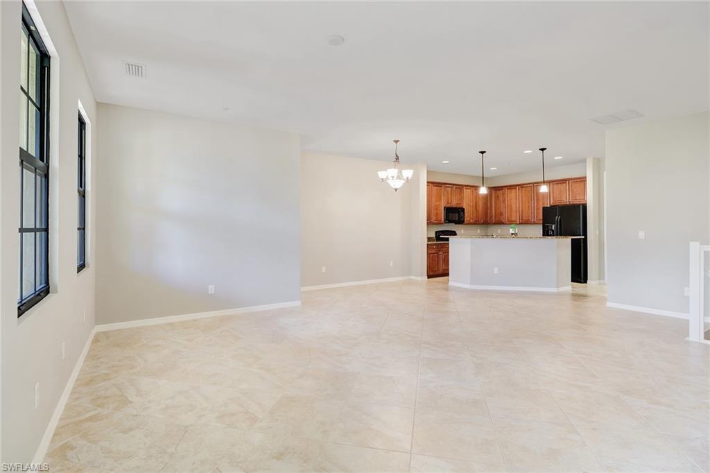 8975 Malibu Street, Unit 1302 Naples, FL 34113 - Photo 7 of 34 a view of a kitchen with a sink and a refrigerator