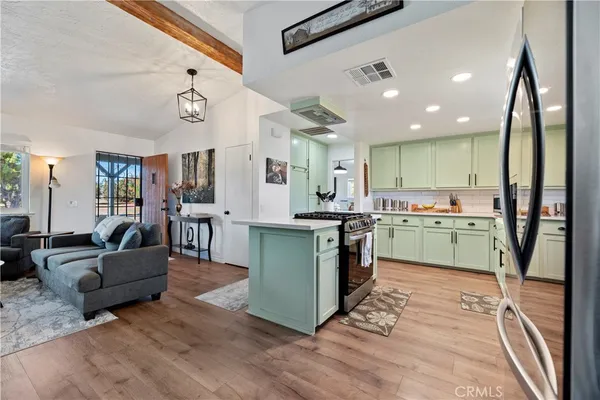 a kitchen with a sink stove and refrigerator