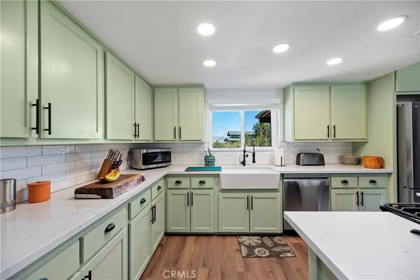 a kitchen with a sink stainless steel appliances and cabinets