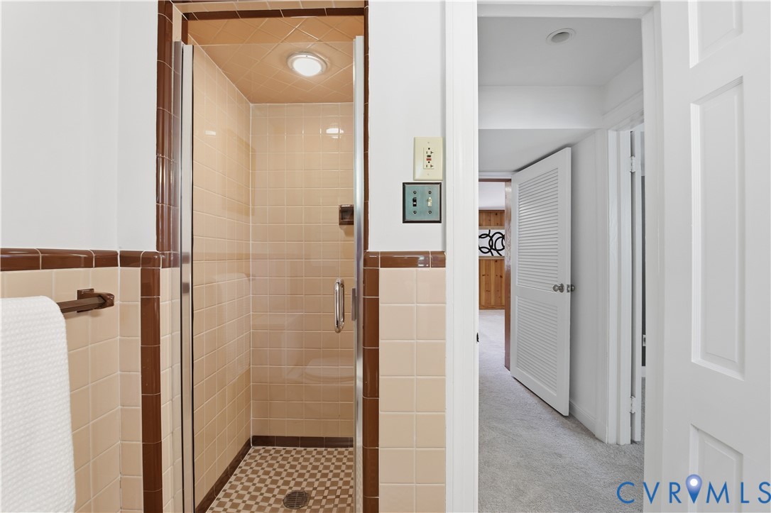 6405 Buckhill Road Richmond, VA 23225 - Photo 37 of 71 Enclosed shower with glass door, beige wall tiling