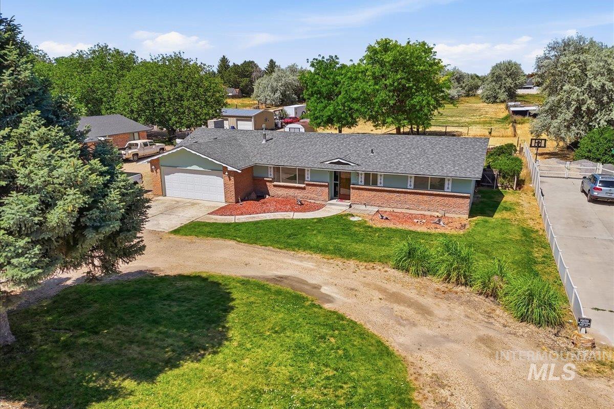 1311 North Middleton Road Nampa, ID 83651 - Photo 5 of 49 Brick and siding ranch-style residence featuring an attached two-car garage, gray shingle roofing, and a concrete driveway