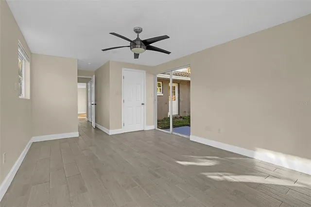 a view of a livingroom with a ceiling fan and window