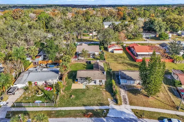 an aerial view of residential houses with outdoor space