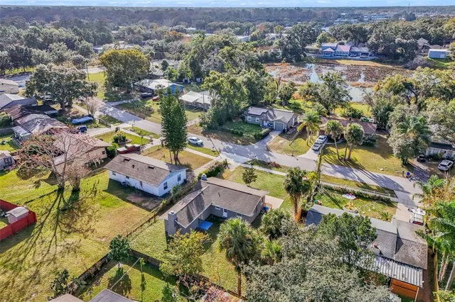 an aerial view of lake and residential houses with outdoor space