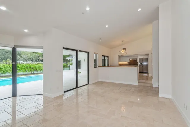 a view of a chandelier fan and entryway