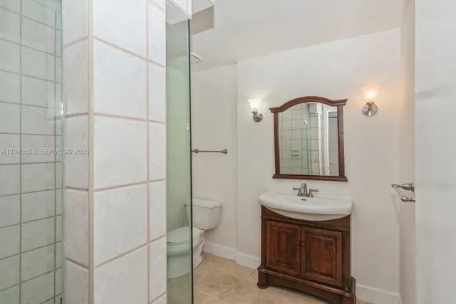 a bathroom with a sink toilet and a mirror