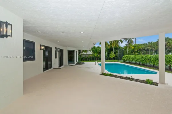 front view of house with swimming pool and yard
