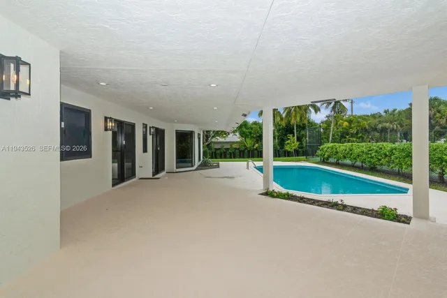 front view of house with swimming pool and yard
