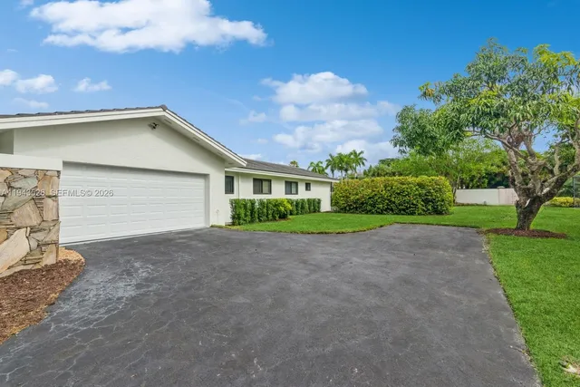 a view of a house with a yard and porch